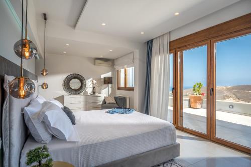 a bedroom with a bed with a view of the ocean at Eunoia Villa Crete in Prasás
