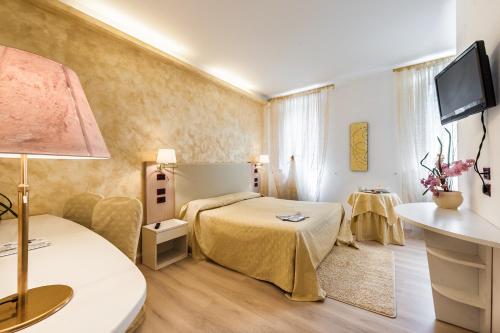 מיטה או מיטות בחדר ב-Hotel Trettenero