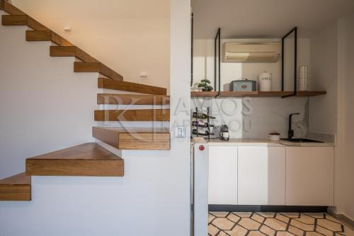 a kitchen with a staircase in a house at Eunoia Villa Crete in Prasás
