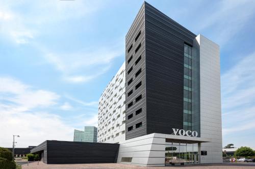 a building with a sign on the front of it at voco Venice Mestre - The Quid, an IHG Hotel in Mestre