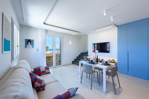 a living room with a couch and a table at Residence Luce del Mare in San Vito lo Capo