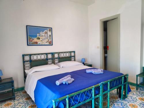 a bedroom with a bed with two teddy bears on it at Hotel Phenicusa in Filicudi