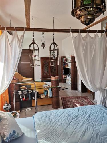 a bedroom with a bed with curtains in it at Samoa in Hoppegarten
