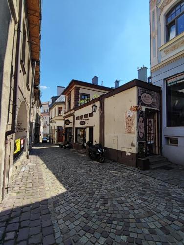 a cobblestone street in a city with buildings at Apartament Podcienie z tarasem Bielsko-Biała Old Town in Bielsko-Biala
