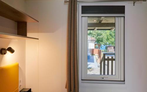 a window in a room with a view of a street at Campeggio Amici di Lazise in Lazise