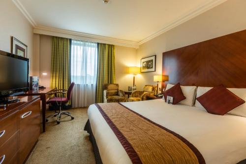 a hotel room with a large bed and a television at Crowne Plaza Birmingham NEC by IHG in Bickenhill