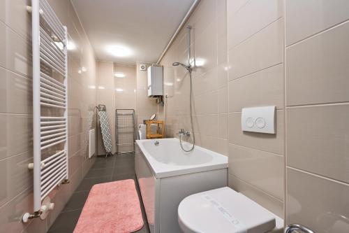 a white bathroom with a toilet and a sink at Exclusive apartment in Varaždin in Varaždin