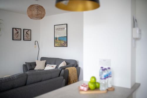 a living room with a couch and a table at End House Inverness in Inverness