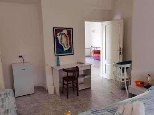 a room with a bed and a table and chairs at Rosy house in Scalea