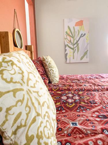 a bed with a comforter and pillows in a bedroom at Havana Nights in Graskop