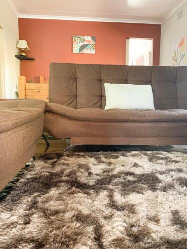 a living room with a couch and a rug at Havana Nights in Graskop
