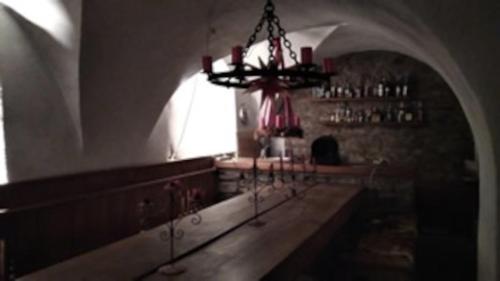 a dark room with a chandelier in a building at Rittergut Schloss Niederforchheim in Forchheim