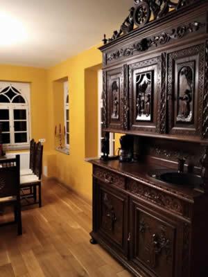 a kitchen with a large wooden cabinet with a sink at Rittergut Schloss Niederforchheim in Forchheim