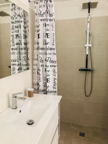 a bathroom with a shower and a white sink at Villa Valentina in Locorotondo