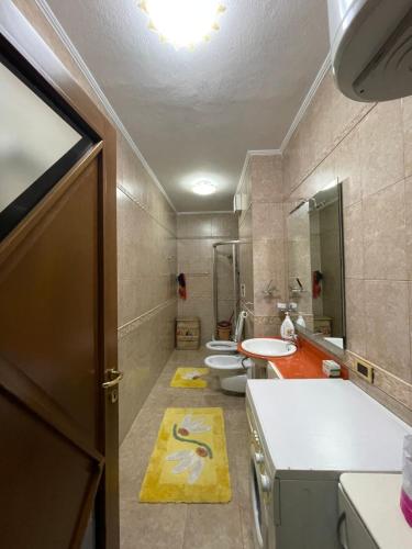 a bathroom with three toilets and a sink and a door at Luxury Center apartment in Tirana