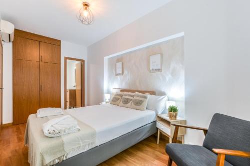 a bedroom with a white bed and a chair at Collection Plaza de España in Madrid