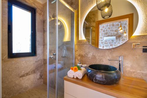 a bathroom with a sink and a glass shower at Water Edge 3 in Kaş