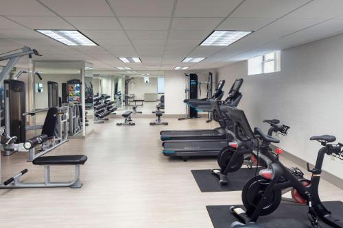 a gym with several treadmills and cardio machines at The Elms Hotel & Spa, a Destination by Hyatt Hotel in Excelsior Springs