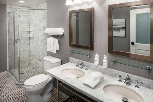 a bathroom with a toilet and a sink and a shower at The Elms Hotel & Spa, a Destination by Hyatt Hotel in Excelsior Springs