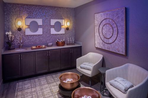a therapy room with two chairs and a table at The Elms Hotel & Spa, a Destination by Hyatt Hotel in Excelsior Springs
