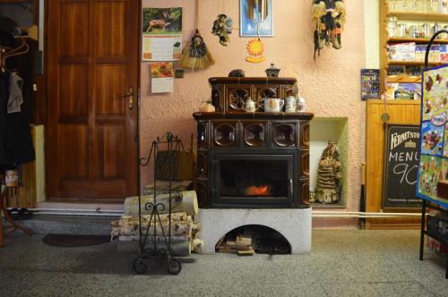 an old stove in a store with a fireplace at Penzion54 & Restaurace in Ostrov