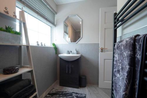 a bathroom with a sink and a mirror at Rose Haven private home between Dungannon & Omagh in Dungannon