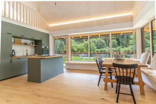 a kitchen and dining room with a table and chairs at NaturparkResort Lausernest in Wildalpen