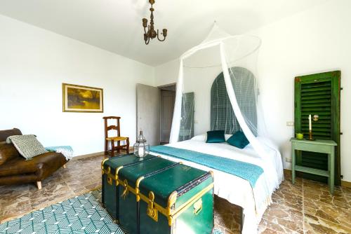 a bedroom with a bed with a white canopy at Hostly - Il Casale dei Ninì in San Giuliano Terme