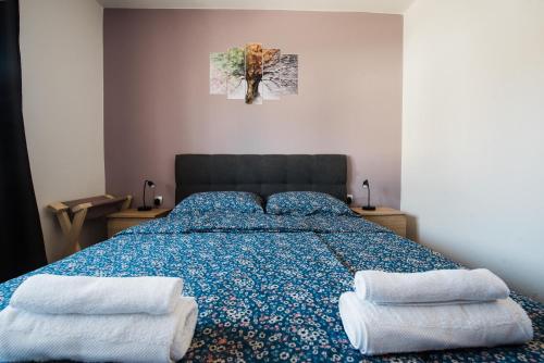 a bedroom with a bed with two pillows on it at Venite apartments in Velika