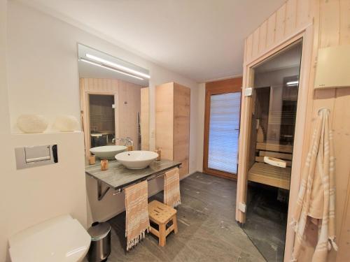 a bathroom with a sink and a toilet at Casa Capricorn Nähe Laax in Sagogn