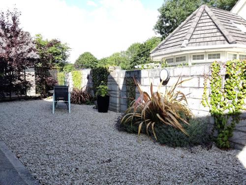 a yard with a fence and a chair and a building at Foxhollow House in Blarney