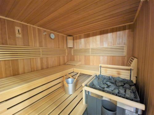 a wooden sauna with a trash can in it at Casa Capricorn Nähe Laax in Sagogn