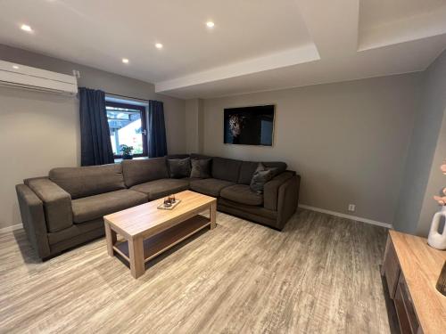 a living room with a couch and a coffee table at Notodden Sentrum Apartment NO 9 in Notodden