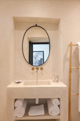a bathroom with a sink and a mirror at Riad Dar Labzar in Marrakesh