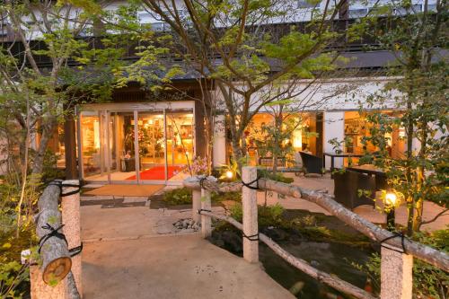 a house with a courtyard with trees and lights at Yumeoi-so in Aso