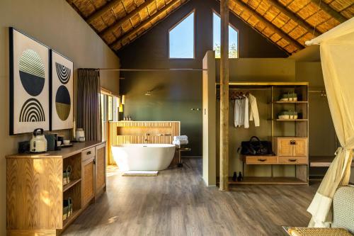 a bathroom with a large tub in a room at Victoria Falls River Lodge in Victoria Falls