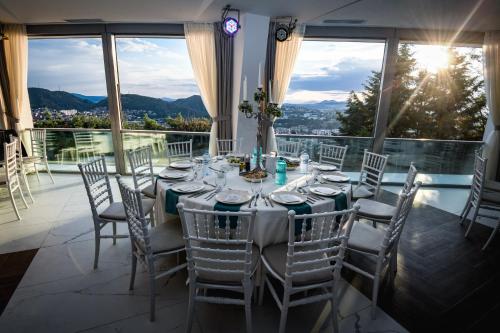 a dining room with a table and chairs at 7even weddings & events in Štip