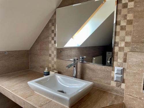 a bathroom with a sink and a mirror at VIP apartment in Mogilany close to Kraków Air con WLAN Highspeed in Mogilany