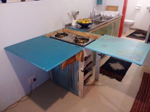 a kitchen with a blue counter with a stove at BohippienJBAY in Jeffreys Bay