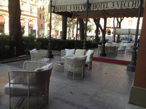 a group of chairs and tables on a patio at Zanhotel Tre Vecchi in Bologna