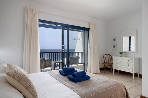 a bedroom with a bed with a view of the ocean at Ajaches 23 in Puerto Calero