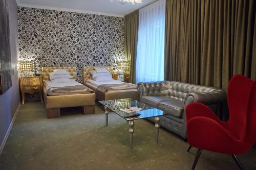 a living room with a couch and a table and chairs at Weekend Boutique Hotel in Chişinău
