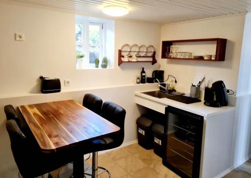 a kitchen with a wooden table and a sink at Grettir Guesthouse in Reykjavík