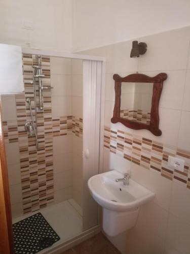 a bathroom with a sink and a shower and a mirror at Il Castello in Castel di Sangro