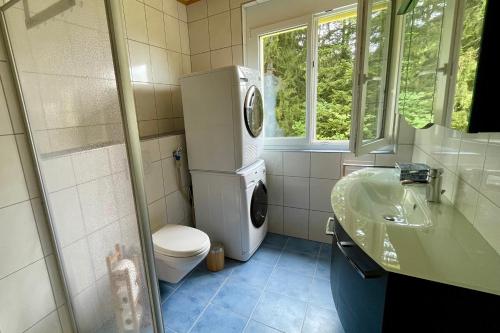 a bathroom with a toilet and a sink at Haus Heimetli - CharmingStay in Flumserberg