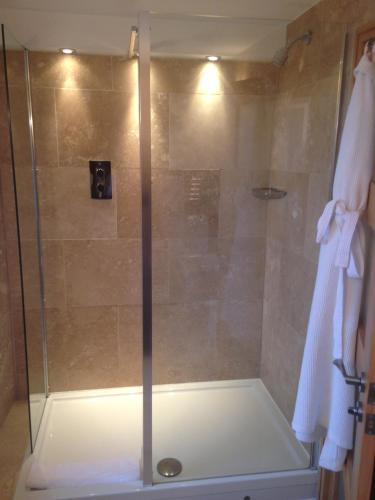 a shower with a glass door in a bathroom at Ennios Boutique Hotel in Southampton