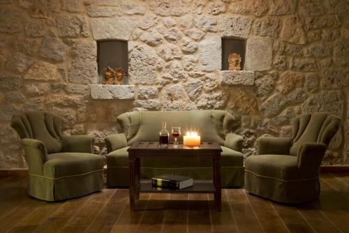 a living room with two chairs and a table at Ellinon Thea Arachova in Arachova