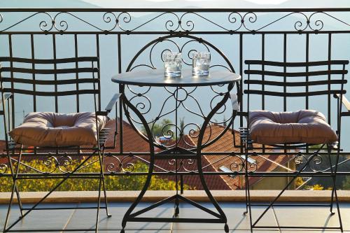 a blue table and two chairs on a balcony at Ellinon Thea Arachova in Arachova