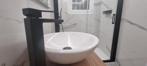 a white toilet in a bathroom with a sink at Principado Benidorm Suites Levante in Benidorm
