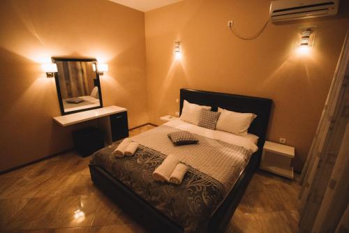 a bedroom with a bed with towels on it at Hotel Liana in Ulcinj